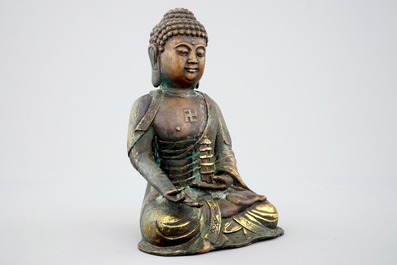 A Sino-Tibetan gilt bronze figure of a seated Buddha, 19th C.