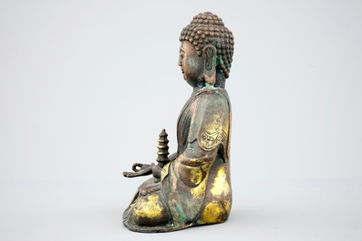 A Sino-Tibetan gilt bronze figure of a seated Buddha, 19th C.