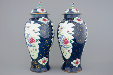A tall pair of Chinese famille rose powder blue ground vases with covers, Qianlong, 18th C.