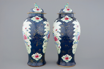 A tall pair of Chinese famille rose powder blue ground vases with covers, Qianlong, 18th C.