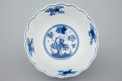 Three Chinese blue and white plates and a lotus shaped cup and saucer, Kangxi