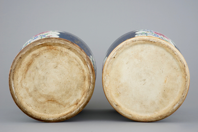 A tall pair of Chinese famille rose powder blue ground vases with covers, Qianlong, 18th C.