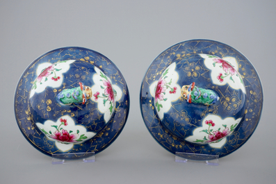 A tall pair of Chinese famille rose powder blue ground vases with covers, Qianlong, 18th C.