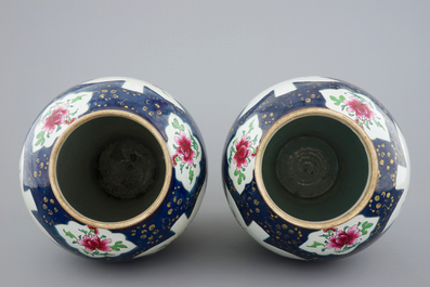 A tall pair of Chinese famille rose powder blue ground vases with covers, Qianlong, 18th C.