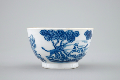 A Chinese blue and white cup and saucer with dogs, Qianlong, 18th C.
