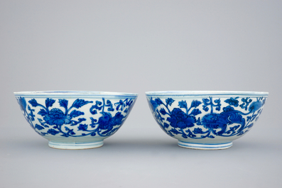 A pair of Chinese blue and white bowls with lions among peony scrolls, late Ming Dynasty