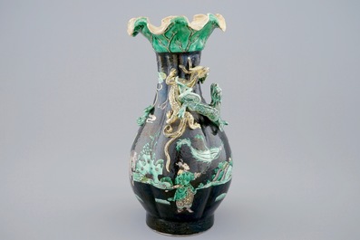 A Chinese famille noire lotus-shaped vase with applied dragons, 19th C.