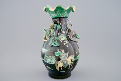 A Chinese famille noire lotus-shaped vase with applied dragons, 19th C.
