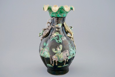 A Chinese famille noire lotus-shaped vase with applied dragons, 19th C.