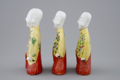 Een set van drie Chinese porseleinen geknielde jongens, 19e eeuw