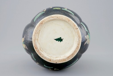 A Chinese famille noire lotus-shaped vase with applied dragons, 19th C.