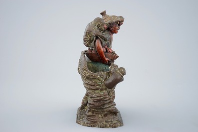 A Japanese terracotta okimono of a fruit vendor with monkeys, Edo/Meiji, 18/19th C.