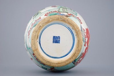 A large Chinese famille verte vase with a continuous scene and elephant handles, 19th C.