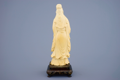 A Chinese ivory figure of a sage with a parchment roll on stand, late 19th C.