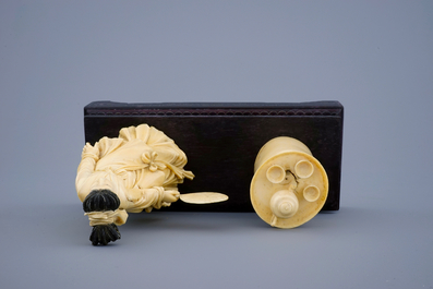 A Chinese carved ivory group of a lady near a tea table on a wood base, 19th C.