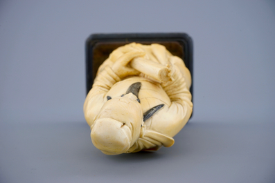 A Chinese ivory figure of a sage with a parchment roll on stand, late 19th C.