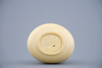 A Chinese carved ivory dragon vase on a wooden base, early 20th C.