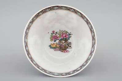A Chinese famille rose eggshell cup and saucer with a cat near a flowervase, Yongzheng, 1723-1735