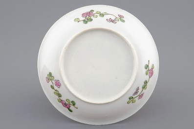 A Chinese famille rose eggshell cup and saucer with a cat near a flowervase, Yongzheng, 1723-1735
