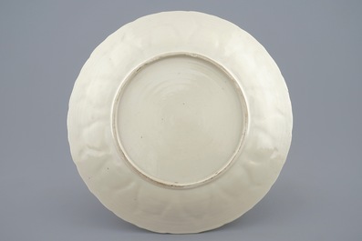 A Chinese moulded famille rose on cream ground plate with a rooster thief, Yongzheng, 1723-1735