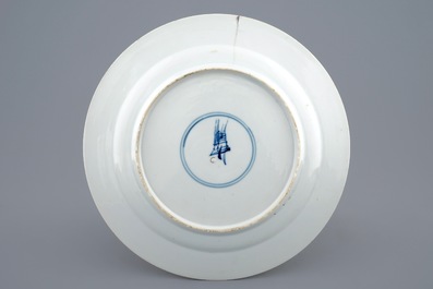 A Chinese famille verte plate with a small boy on a table, Kangxi