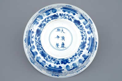 A Chinese blue and white dragon bowl with floral design, Kangxi