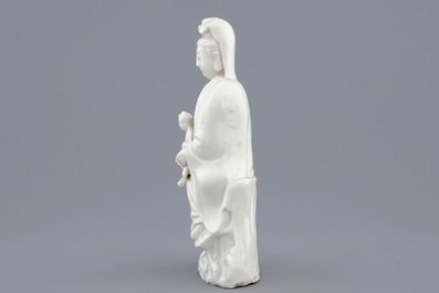 A Chinese Dehua blanc de Chine model of Guanyin with child, 19th C.