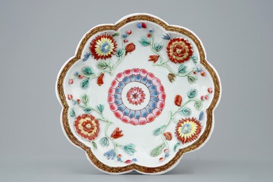 A Chinese moulded and applied famille rose teapot and cover on stand, Yongzheng, 1723-1735