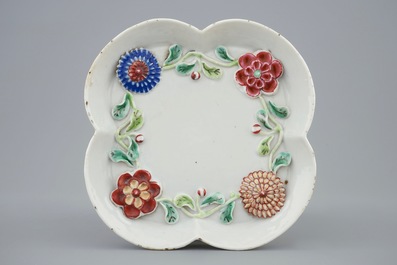 A Chinese moulded and applied famille rose teapot and cover on stand, Yongzheng, 1723-1735