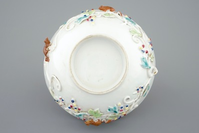 A Chinese relief-decorated famille rose cup and saucer with squirrels, Yongzheng, 1723-1735