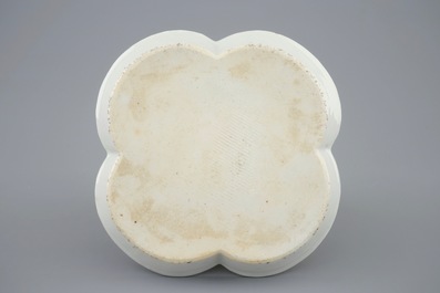 A Chinese moulded and applied famille rose teapot and cover on stand, Yongzheng, 1723-1735