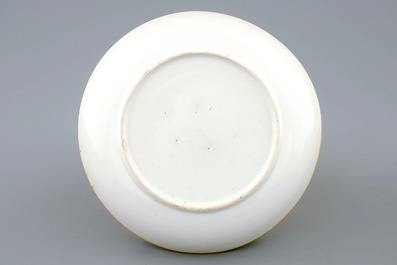 A Chinese clobbered blanc de chine cup and saucer with moulded dragon design, 18th C.