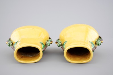 A pair of Chinese yellow glazed hu-shaped vases on stand, 19/20th C.