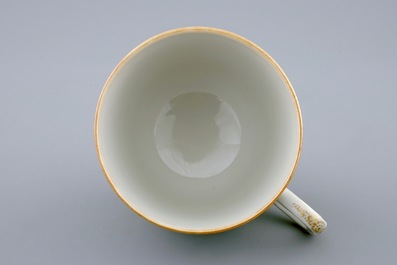 A Chinese famille rose cup and saucer with cherubs, Qianlong, 18th C.