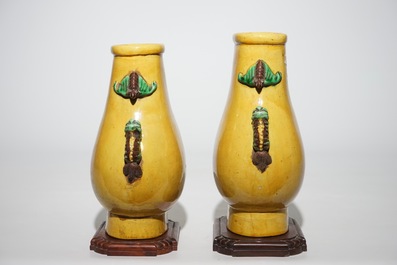 A pair of Chinese yellow glazed hu-shaped vases on stand, 19/20th C.