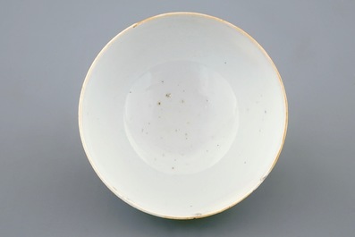 A Chinese clobbered blanc de chine cup and saucer with moulded dragon design, 18th C.