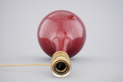 A Chinese monochrome red bottle vase mounted as a lamp, 19th C.