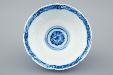 A Chinese blue and white soft paste  moulded cup and saucer, Qianlong, 18th C.