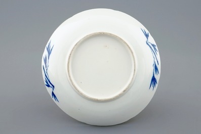 A Chinese blue and white soft paste  moulded cup and saucer, Qianlong, 18th C.