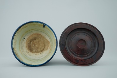 A Chinese monochrome blue cylincrical tripod incense burner with wood lid, 19th C.