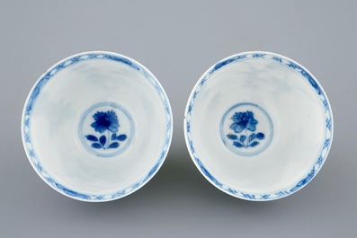 A pair of Chinese blue and white wine cups with 4 floral patterns, six-character mark, Kangxi