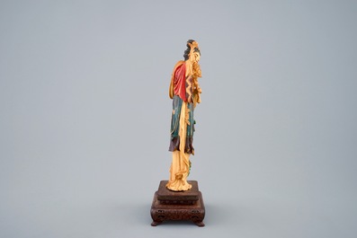 Een polychrome Chinese ivoren figuur van Guanyin op houten sokkel, 19e eeuw