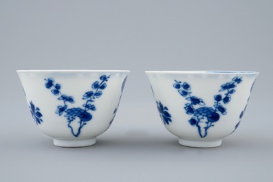 A pair of Chinese blue and white wine cups with 4 floral patterns, six-character mark, Kangxi