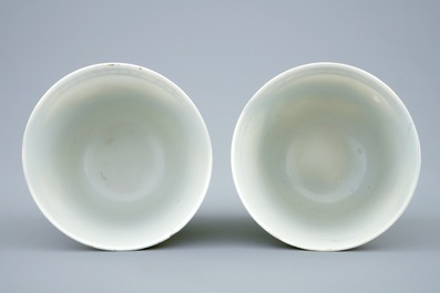 A pair of Chinese grisaille and gilt cups and saucers with immortals, Qianlong, 18th C.
