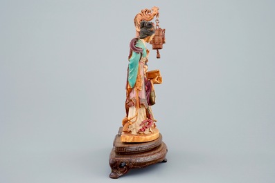 A Chinese polychrome carved ivory group on wooden base, 19th C.