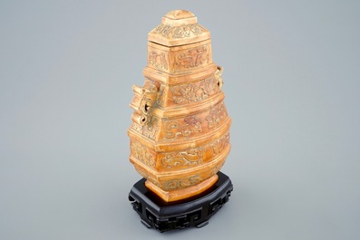 A Chinese parcel-gilt ivory vase and cover on wooden stand, 19th C.