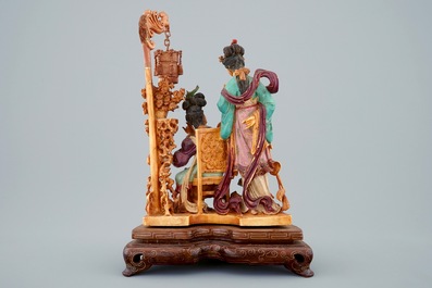 A Chinese polychrome carved ivory group on wooden base, 19th C.