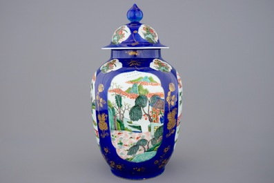 A Chinese famille verte powder blue ground vase and cover, 19th C.