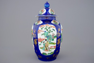 A Chinese famille verte powder blue ground vase and cover, 19th C.