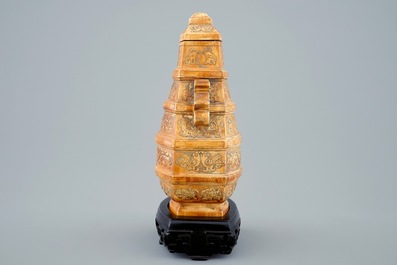 A Chinese parcel-gilt ivory vase and cover on wooden stand, 19th C.